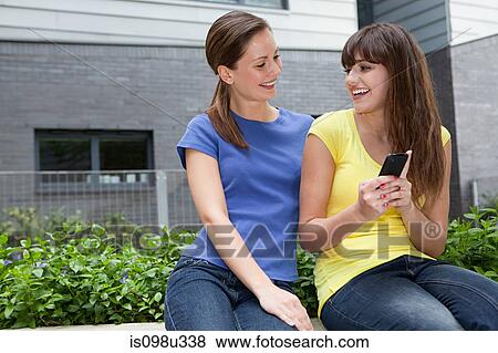 Female friends with smartphone View Large Photo Image Stock Photo - Female friends with smartphone. Fotosearch
