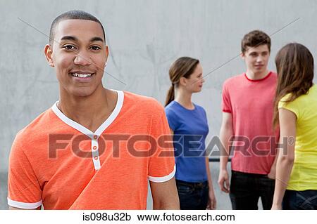 Stock Image - Young man and friends. Fotosearch