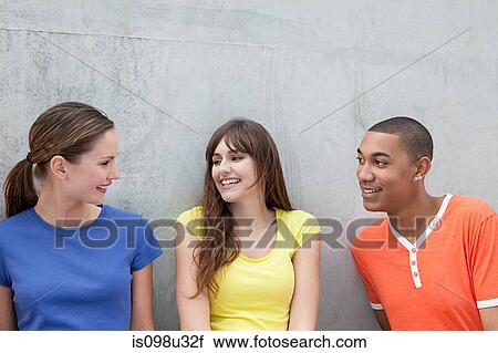 Young man and two young women View Large Photo Image Stock Image - Young man and two young women. Fotosearch