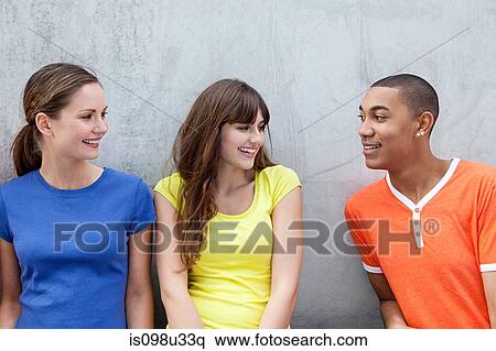 Young man and two young women View Large Photo Image Stock Photography - Young man and two young women. Fotosearch