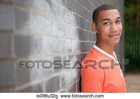 Young man by wall View Large Photo Image Stock Image - Young man by wall. Fotosearch