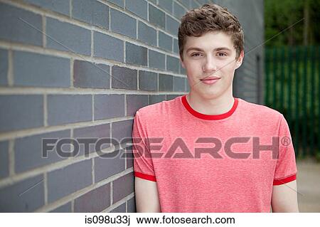 Young man by wall View Large Photo Image Stock Image - Young man by wall. Fotosearch
