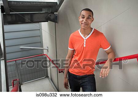Young man on stairwell View Large Photo Image Stock Image - Young man on stairwell. Fotosearch