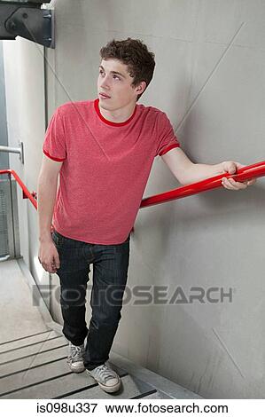 Young man on stairwell View Large Photo Image Stock Photo - Young man on stairwell. Fotosearch