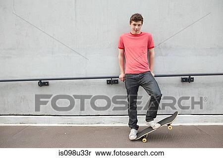 Stock Photography - Young man with skateboard. Fotosearch