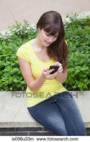 Young woman with smartphone View Large Photo Image Picture - Young woman with smartphone. Fotosearch