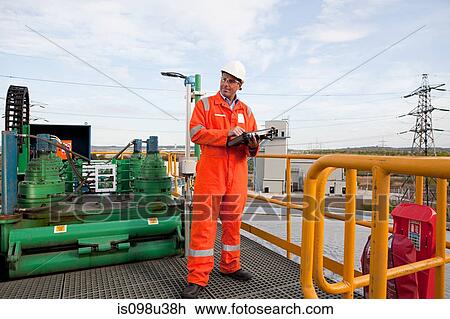 Stock Image - Engineer at industrial plant. Fotosearch