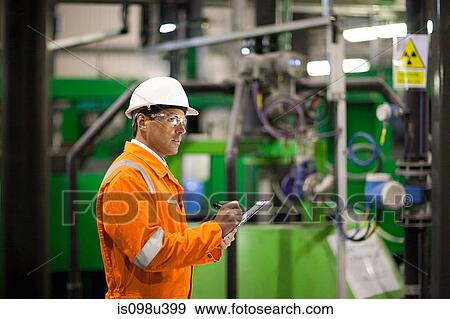 Engineer inspecting machinery in factory View Large Photo Image Stock Photo - Engineer inspecting machinery in factory. Fotosearch
