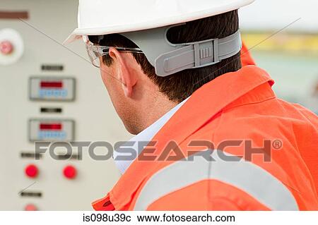 Engineer looking at control panel View Large Photo Image Stock Image - Engineer looking at control panel. Fotosearch