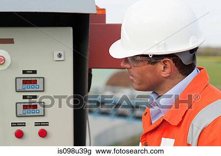 Engineer looking at control panel View Large Photo Image Stock Image - Engineer looking at control panel. Fotosearch