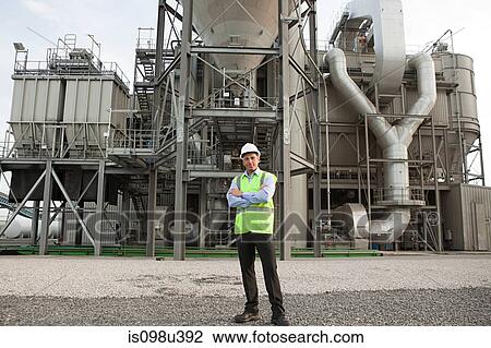 Engineer standing outside factory View Large Photo Image Stock Image - Engineer standing outside factory. Fotosearch