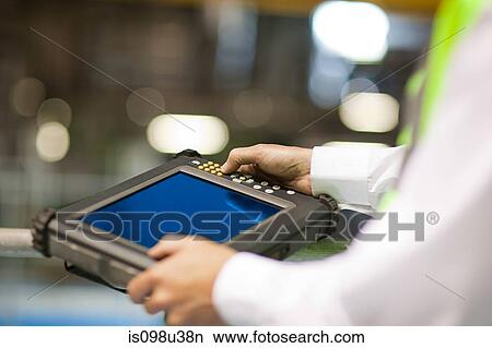 Engineer using handheld computer View Large Photo Image Picture - Engineer using handheld computer. Fotosearch