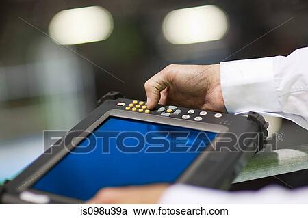 Engineer using handheld computer View Large Photo Image Stock Image - Engineer using handheld computer. Fotosearch