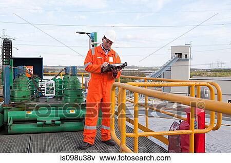 Engineer using handheld computer View Large Photo Image Stock Photo - Engineer using handheld computer. Fotosearch