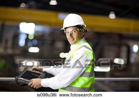 Engineer with handheld computer View Large Photo Image Stock Image - Engineer with handheld computer. Fotosearch