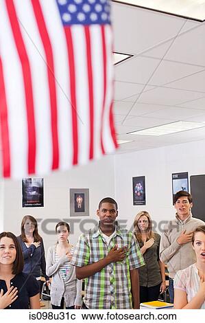 Stock Image - High school students swearing allegiance to the American flag. Fotosearch