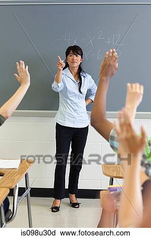 High school students with arms raised in classroom View Large Photo Image Stock Image - High school students with arms raised in classroom. Fotosearch