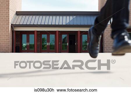 Male high school student running away from school View Large Photo Image Stock Image - Male high school student running away from school. Fotosearch