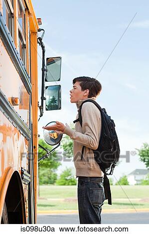 Male high school student standing outside school bus door View Large Photo Image Stock Image - Male high school student standing outside school bus door. Fotosearch