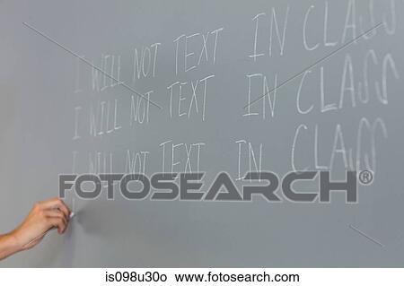 Male high school student writing lines on blackboard View Large Photo Image Picture - Male high school student writing lines on blackboard. Fotosearch