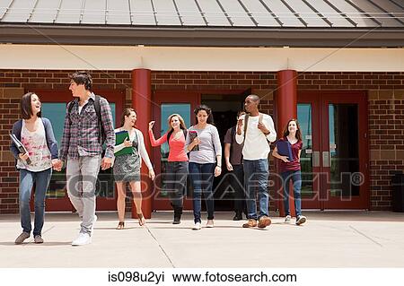 Stock Image - High school students leaving school building. Fotosearch