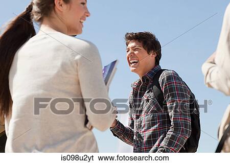 Stock Photograph - High school students talking and laughing outside. Fotosearch