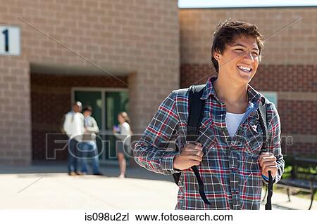 Male high school student outside school building View Large Photo Image Stock Image - Male high school student outside school building. Fotosearch