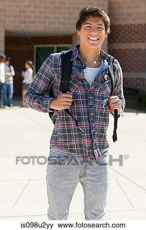 Male high school student outside school building View Large Photo Image Stock Photo - Male high school student outside school building. Fotosearch