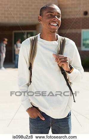 Male high school student outside school building View Large Photo Image Stock Photo - Male high school student outside school building. Fotosearch