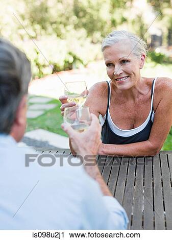 Couple toasting with wine outdoors View Large Photo Image Stock Image - Couple toasting with wine outdoors. Fotosearch