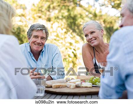 Friends at meal outdoors View Large Photo Image Picture - Friends at meal outdoors. Fotosearch