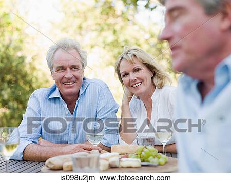 Friends at meal outdoors View Large Photo Image Picture - Friends at meal outdoors. Fotosearch