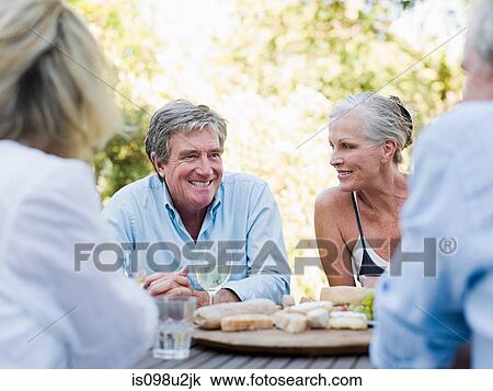 Friends at meal outdoors View Large Photo Image Stock Image - Friends at meal outdoors. Fotosearch