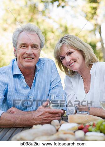 Mature couple at meal outdoors View Large Photo Image Stock Photograph - Mature couple at meal outdoors. Fotosearch