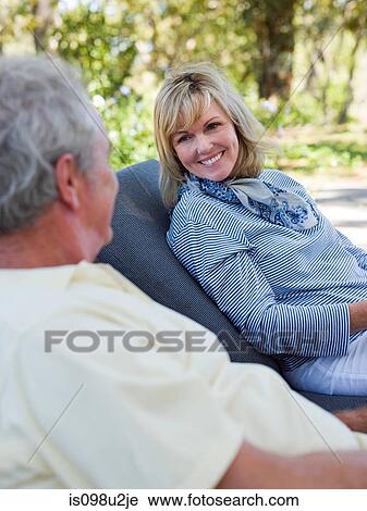 Mature couple on loungers in garden View Large Photo Image Stock Image - Mature couple on loungers in garden. Fotosearch