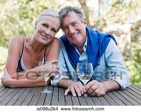 Mature couple outdoors with wine View Large Photo Image Picture - Mature couple outdoors with wine. Fotosearch