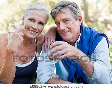 Mature couple outdoors with wine View Large Photo Image Stock Photo - Mature couple outdoors with wine. Fotosearch