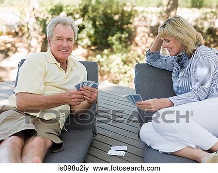 Mature couple playing cards outdoors View Large Photo Image Stock Photo - Mature couple playing cards outdoors. Fotosearch