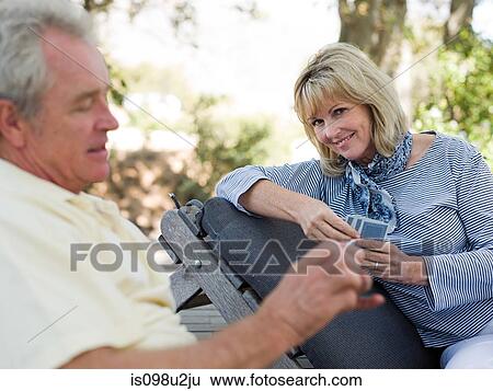 Mature couple playing cards outdoors View Large Photo Image Stock Photograph - Mature couple playing cards outdoors. Fotosearch