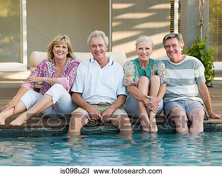 Mature friends by swimming pool View Large Photo Image Stock Image - Mature friends by swimming pool. Fotosearch
