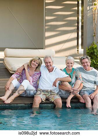 Mature friends by swimming pool View Large Photo Image Stock Image - Mature friends by swimming pool. Fotosearch