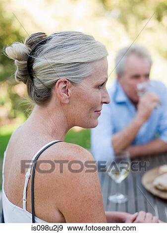 Mature woman at table outdoors View Large Photo Image Stock Photo - Mature woman at table outdoors. Fotosearch