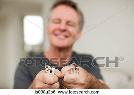 Man with broken cigarettes View Large Photo Image Stock Photograph - Man with broken cigarettes. Fotosearch