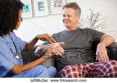 Nurse visiting man with wrist injury View Large Photo Image Stock Image - Nurse visiting man with wrist injury. Fotosearch