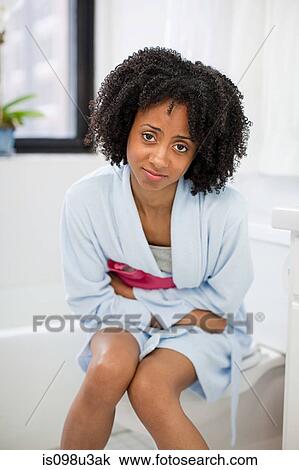 Stock Image - Woman experiencing period pains. Fotosearch
