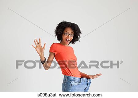 Woman with loose jeans View Large Photo Image Stock Photograph - Woman with loose jeans. Fotosearch