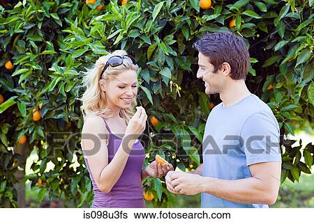 Stock Photograph - Couple by orange tree. Fotosearch