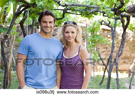 Couple in a vineyard View Large Photo Image Stock Image - Couple in a vineyard. Fotosearch
