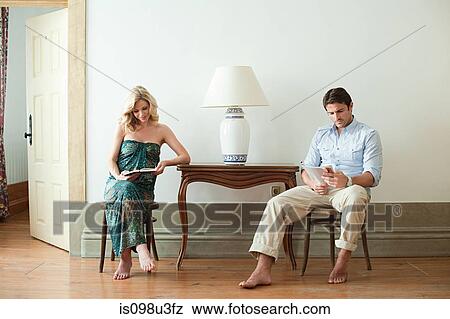 Couple reading in hotel room View Large Photo Image Stock Photo - Couple reading in hotel room. Fotosearch