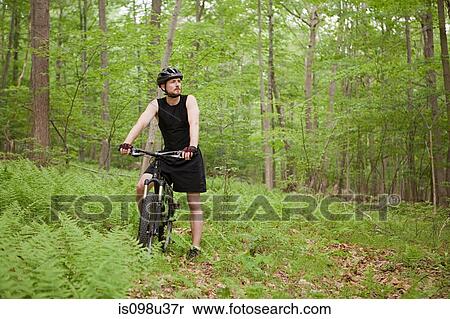 Stock Photography - Male cyclist in forest. Fotosearch